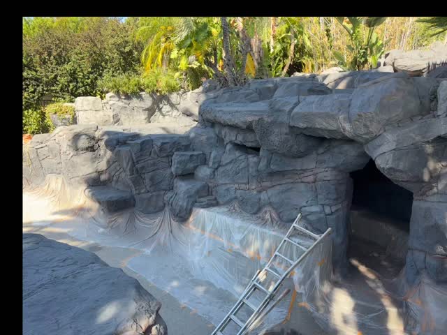 Pool pebble finish and rockwork during restoration