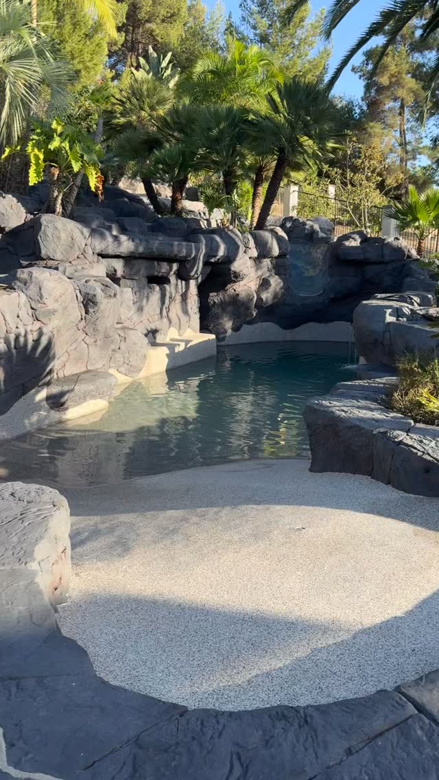The lagoon pool beginning to refill beneath palms and rockwork